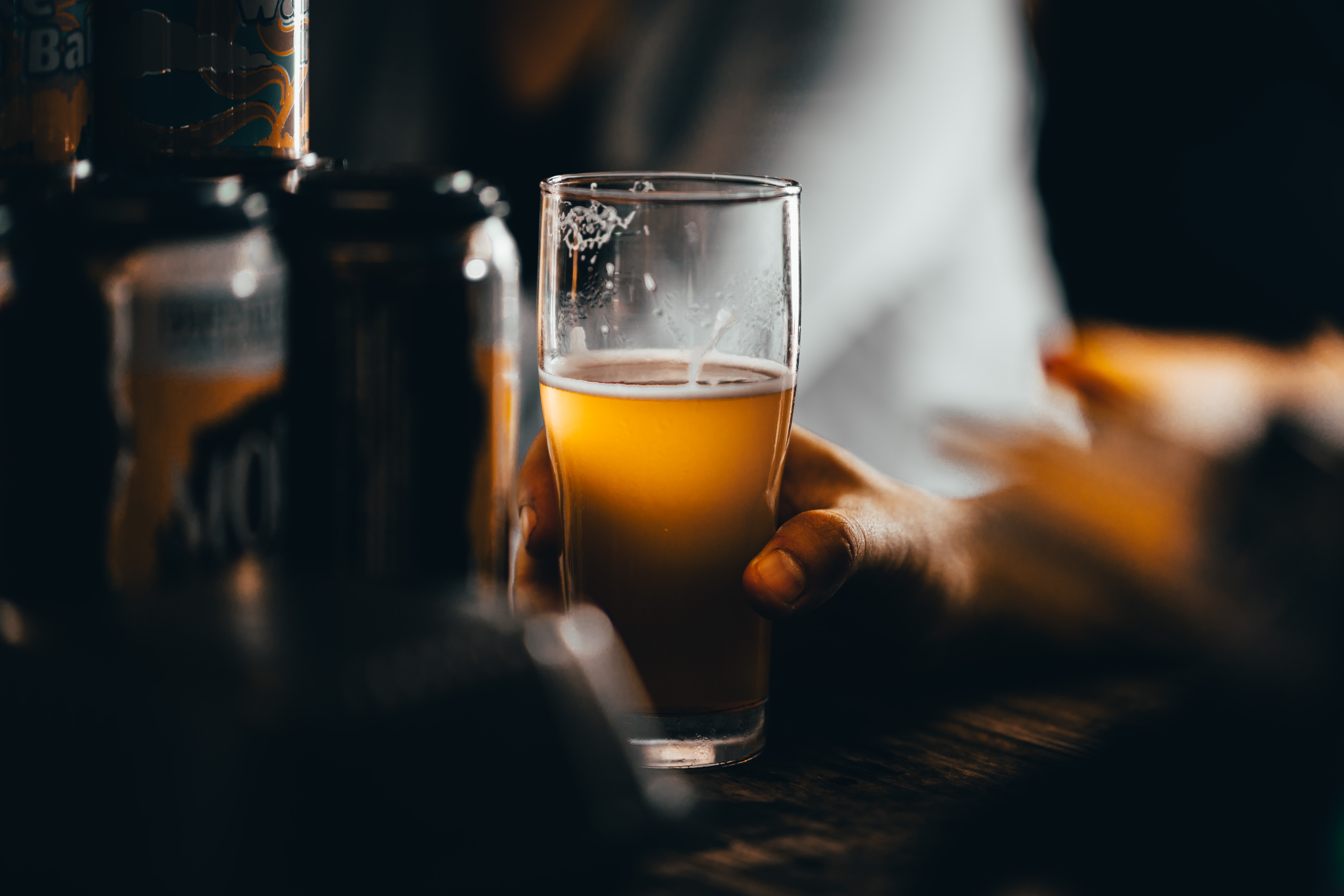 Beer in a persons hand at a Vancouver brewery