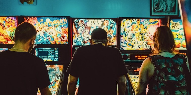 3 friends playing in an arcade in Vancouver