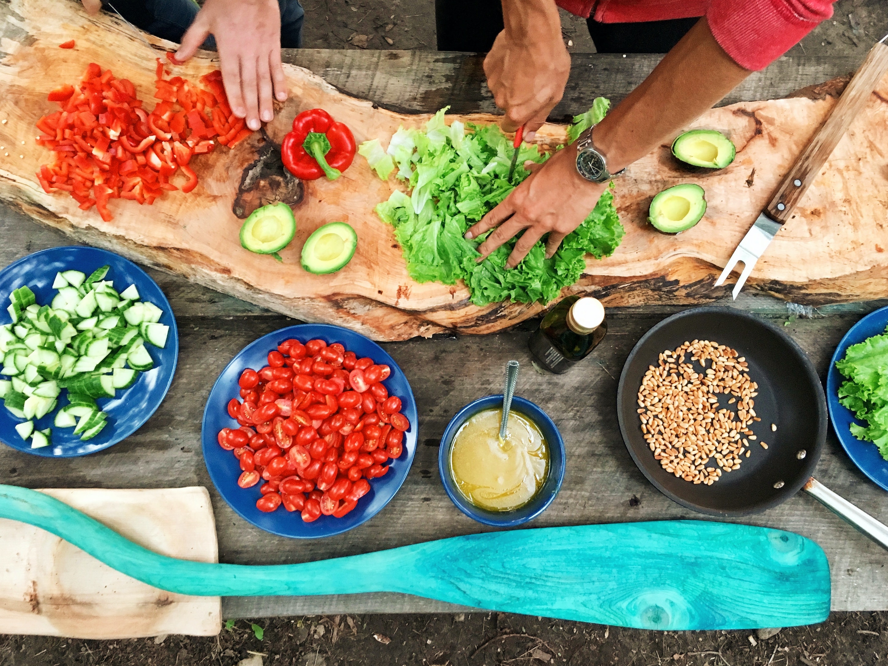 people cooking salad outside