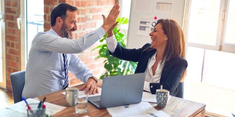 Happy client and professional high fiving